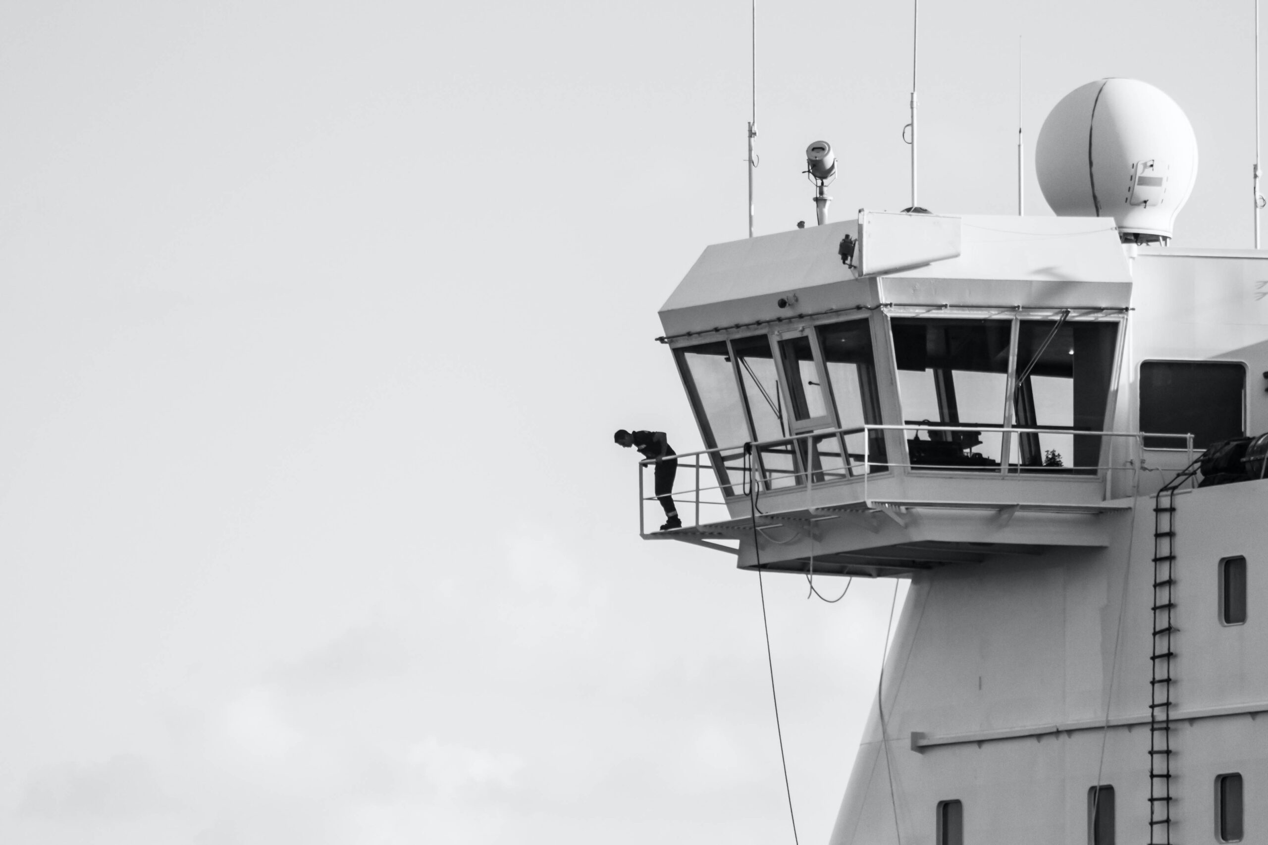 person looking down from on top of a control tower at an airport.